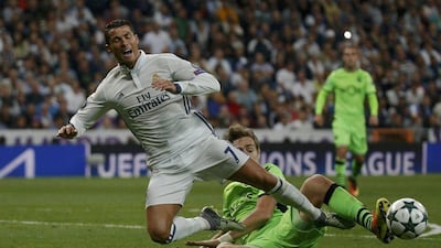Real Madrid's Cristiano Ronaldo and Sporting Portugal's Sebastian Coates in action. Juan Medina / Reuters