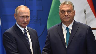 Hungarian Prime Minister Viktor Orban, right, and Russian President Vladimir Putin shake hands in Budapest in October 2019. AFP