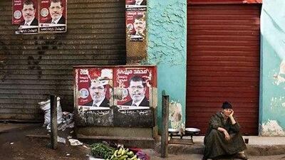 An Egyptian street vendor waits for customers in Cairo yesterday. Political uncertainty has put Egypt in a more fragile place than it was before the revolution. Bernat Armangue / AP Photo