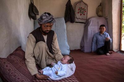Ahmed Reza, 34, holds his son Abbas at his home in Kabul. His wife Rokaia was killed in the attack on the maternity ward in Dasht-e-Barchi. Stefanie Glinski for The National
