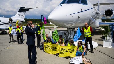 Environmental activists engage in a climate protest at the European Business Aviation Convention and Exhibition at Geneva Airport in Switzerland. EPA