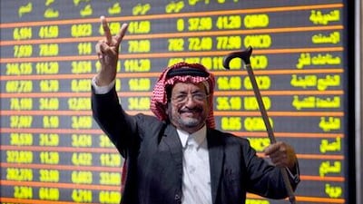 An investor celebrates after the Qatari stock market went up 5.32 percent at its close, at Doha Securities Market in Doha in this December 2, 2009 file photo. Looking beyond the shock of Dubai's debt crisis, investors in the world's top oil exporting region see some of the most compelling stories globally, especially in Saudi Arabia and Qatar whose benchmark indexes surged early in the year. To match Feature FRONTIERS/GULF REUTERS/ Fadi Al-Assaad/Files (QATAR - Tags: BUSINESS)