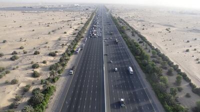 Police on the ground hold up traffic so the Dubai Police helicopter can land on Sheikh Mohammed bin Zayed Road.