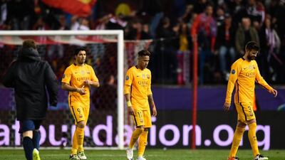 Gerard Pique, right, Neymar, centre, and Luis Suarez, leave the pitch after Barcelona's defeat to Atletico Madrid. Mike Hewitt / Getty Images