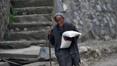 A Kashmiri man carries a pillow as he walks along the road at Ledhan village, west of Srinagar. Danish Ismail / Rueters