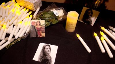 Pictures of Noel Sparks are seen during a candlelight vigil. AP Photo