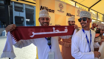 Omani fans support Qatar during the final against Japan in Abu Dhabi. Victor Besa / The National