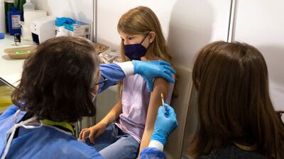 A girl receives her first shot of a Covid-19 vaccine in Vienna. Authorities began vaccinating children between 5 and 11 against coronavirus in the capital on Monday. AFP