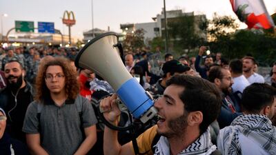 Protesters shout slogans as they block the highway leading to the Presidential palace during a protest to demand the formation of a new government in Baabda, east Beirut. EPA