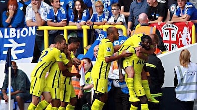 Emmanuel Adebayor is mobbed by his Tottenham teammates after a goal in the side's 201 win over Schalke on Saturday. EPA