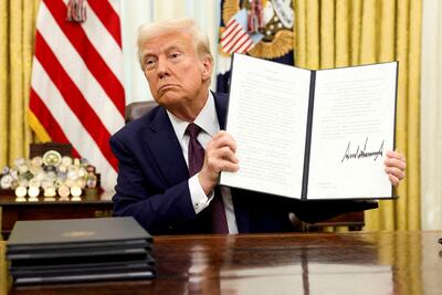 President Donald Trump holds a signed executive order on AI, in the Oval Office of the White House. Reuters