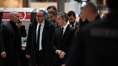 French Interior Minister Gerald Darmanin, third left, arrives at Gare du Nord train station. AFP