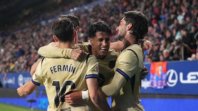 Barcelona players celebrate their crucial 2-1 win over Osasuna. Getty Images