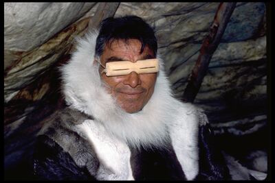 An Inuit man wears wooden glasses designed to reduce the glare from the snow in Baker Lake, Northwest Territories. Getty