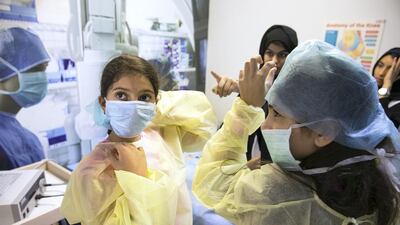 Children play doctor at the OR surgery booth at the Science Festival. Silvia Razgova / The National