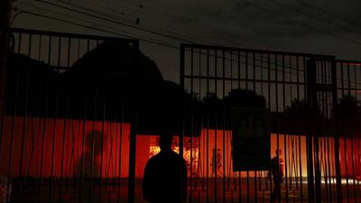 The red lights of police car reflect off a wall outside the Media Village 3 in Rio de Janeiro. Shannon Stapleton / Reuters