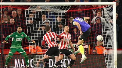 Tottenham Hotspur's Harry Kane, right, heads wide of the goal during the FA Cup fifth round match at Bramall Lane. PA
