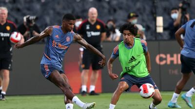 Manchester United forward Marcus Rashford, left, shoots in training. AFP