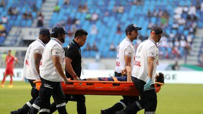 Tanaboon Kesarat of Thailand is stretchered off during the game.