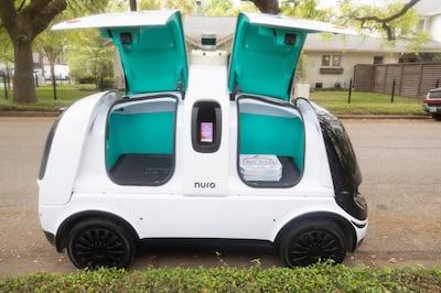 The Nuro R2 robot delivers the pizza order.