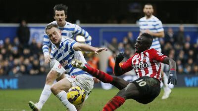 Queens Park Rangers defender Clint Hill, left, challenges Southampton's Sadio Mane during their English Premier League match at Loftus Road in London on February 7, 2015. Stefan Wermuth / Reuters