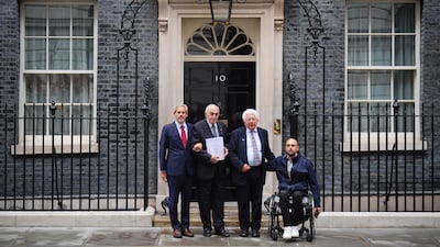 Legal expert Victor Kattan, businessman Munib al-Masri, historian Avi Shlaim, and grandson Munib Masri with the 'Britain Owes Palestine' 400-page legal petition outside Downing Street. PA