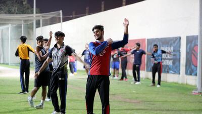 Hassan Khan takes part in a warmup at Sharjah Cricket Academy.