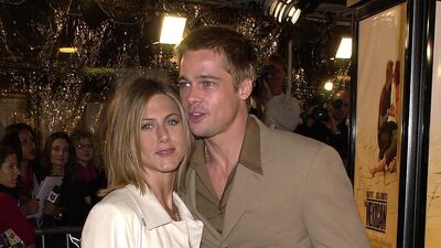 Brad Pitt, in a taupe suit, and Jennifer Aniston arrive for the premiere of 'The Mexican' on February 23, 2001 in Westwood, California. Getty Images