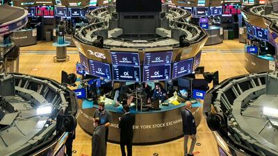 Traders on the floor of the New York Stock Exchange. Stocks around the world are tumbling on worries the worsening pandemic will mean more restrictions on businesses and drag down the economy. AP