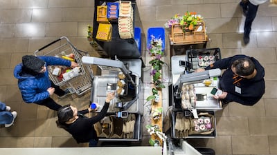 Shoppers use a self-checkout counter at a Whole Foods grocery store in Washington. The US consumer price index rose 0.3 per cent last month, rising 3.1 per cent on an annual basis, down from 3.4 per cent in December. EPA