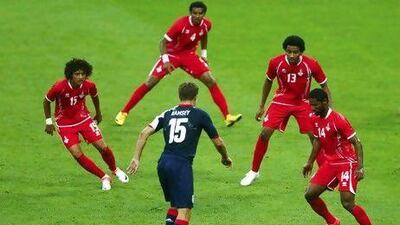 From left to right, the UAE’s Omar Abdulrahman, Mohamed Ahmad, Khamis Ismail and Abdelaziz Sanqour look to stop Britain’s midfielder Aaron Ramsey. Eddie Keogh / Reuters