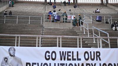 People sit and wait at the National Sports stadium where the official funeral for Robert Mugabe is to be held in Harare, on September 14, 2019. Former Zimbabwe leader Robert Mugabe will be given a state funeral with a dozen African leaders expected to pay tribute to a man lauded as a colonial-era liberation hero. Mugabe, who died last week in Singapore aged 95, left Zimbabwe torn over the legacy of his 37-year rule marked by brutal repression and economic crisis. AFP