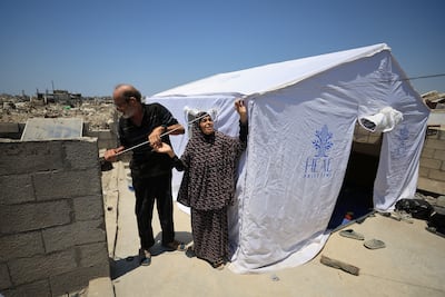 Displaced Palestinians outside a tent on a rooftop in Gaza city. Reuters