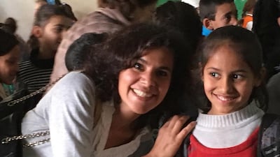 Rudayna Abdo, founder of NGO Thaki, posing with a Syrian child at a Social Support Society school in the Bekaa Valley in Lebanon. Thaki seeks to provide laptops from donors to centres educating refugee and disadvantaged children in Lebanon and Jordan. Courtesy Rudayna Abdo