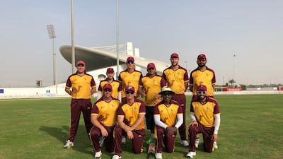 Members of the Abu Dhabi Gentlemen’s Cricket Club in their yellow-and-maroon kit at the Sheikh Zayed Cricket Stadium. Courtesy Abu Dhabi Gentlemen’s Cricket Club