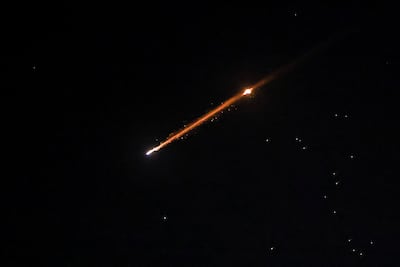An Iranian missile with cluster munitions flies over the city, amid the US-Israeli conflict with Iran, in Jerusalem, March 20, 2026. Reuters