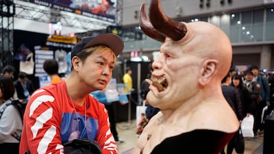 A visitor looks at artwork displayed during the Tokyo Comic Con 2018 at Makuhari Messe in Chiba, Japan. EPA