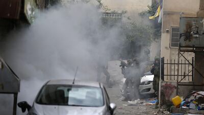 Israeli troops fire tear gas at Palestinian youth in the Amari refugee camp near Ramallah in the occupied West Bank after they stormed the camp on May 28, 2018. Abbas Momani / AFP