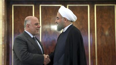 Iran's president Hassan Rouhani, right, welcomes Iraqi prime minister Haider Al Abadi at his office in Tehran, Iran on June 20, 2017. Iranian Presidency Office via AP