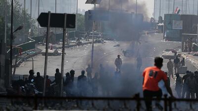 Iraqi riot police fire tear gas to disperse anti-government protesters gathering on bridge in central Baghdad, Iraq, Saturday, Nov. 9, 2019. AP