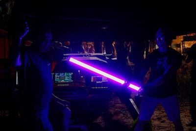 Crew members pose with alight during the filming of 'Jiu Jitsu'. AFP