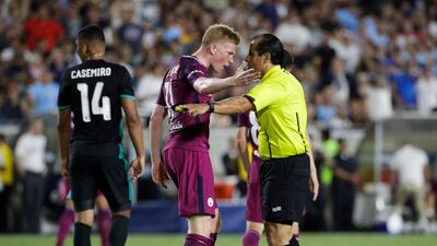 Manchester City's Kevin De Bruyne, front left, argues with an official. Jae C Hong / AP Photo