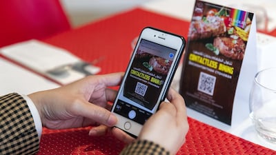 A barcode is scanned for contactless service at Ramada Hotel and Suites by Wyndham Dubai JBR. Reem Mohammed / The National