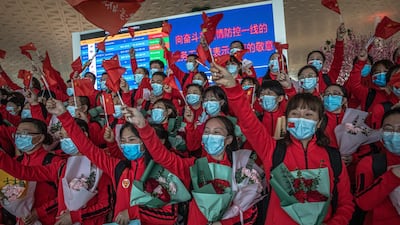 Medical workers from The First Bethune Hospital of Jilin University cheer during a ceremony at the airport as they prepare to leave after the lockdown was lifted in Wuhan, China. EPA