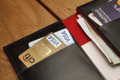 Manage credit card spending and pay cards off in full so the interest does not build up. Antonie Robertson / The National