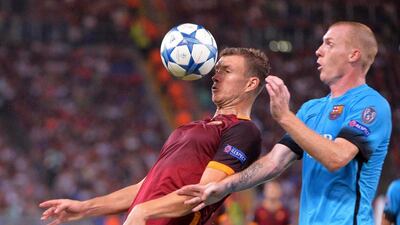 AS Roma's Edin Dzeko goes to control the ball, challenged by Barcelona's Jeremy Mathieu during their Champions League match on Wednesday. Maurizio Brambatti / EPA