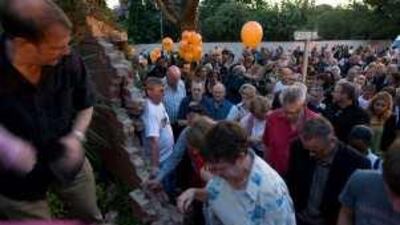 People walk into Goethe Institute in Johannesburg, South Africa, after the part of the wall around the institution was torn down in commemoration of the 20th anniversary of the demolition of the Berlin Wall.