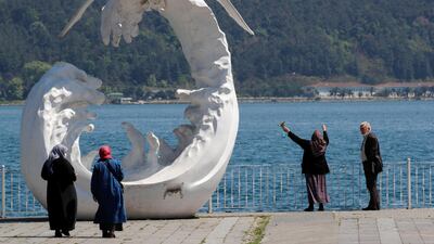 Senior Turkish citizens who were not allowed to go out of their houses since April 4 enjoy a sunny day next to the sea, after being exempted from curfew for four hours, in Istanbul. Reuters