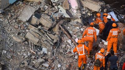 Rescue workers search for people in the rubble of a collapsed five-storey apartment building in Mahad, about 170 kilometres from India's financial capital of Mumbai. AFP