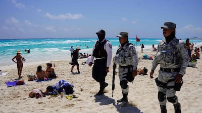 Members of the Mexican Navy and National Guard patrol the tourist beach area of Cancun. AFP